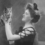 black and white photo of white woman holding a cat