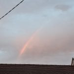 rainbow above a roof