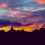 a dark sunset with orange and purple clouds