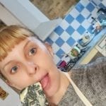 a blonde lady licking a spatula