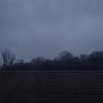 dark, grey, cloudy sky with trees