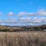 hills of the french countryside, blue sky with white puffy clouds