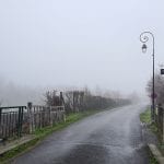 a road with fog in the distance