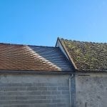 a roof with a bit of frost where there is shade from the connecting roof