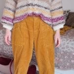 the mid section of someone wearing dark yellow corduroy trousers