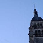 the top of a church on a dark blue sky