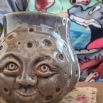 a mug with a moon face