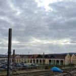 a cloudy sky above train tracks