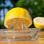 a lemon on a glass lemon squeezer thingy