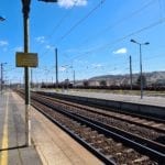 Train tracks and platforms with blue sky in the background