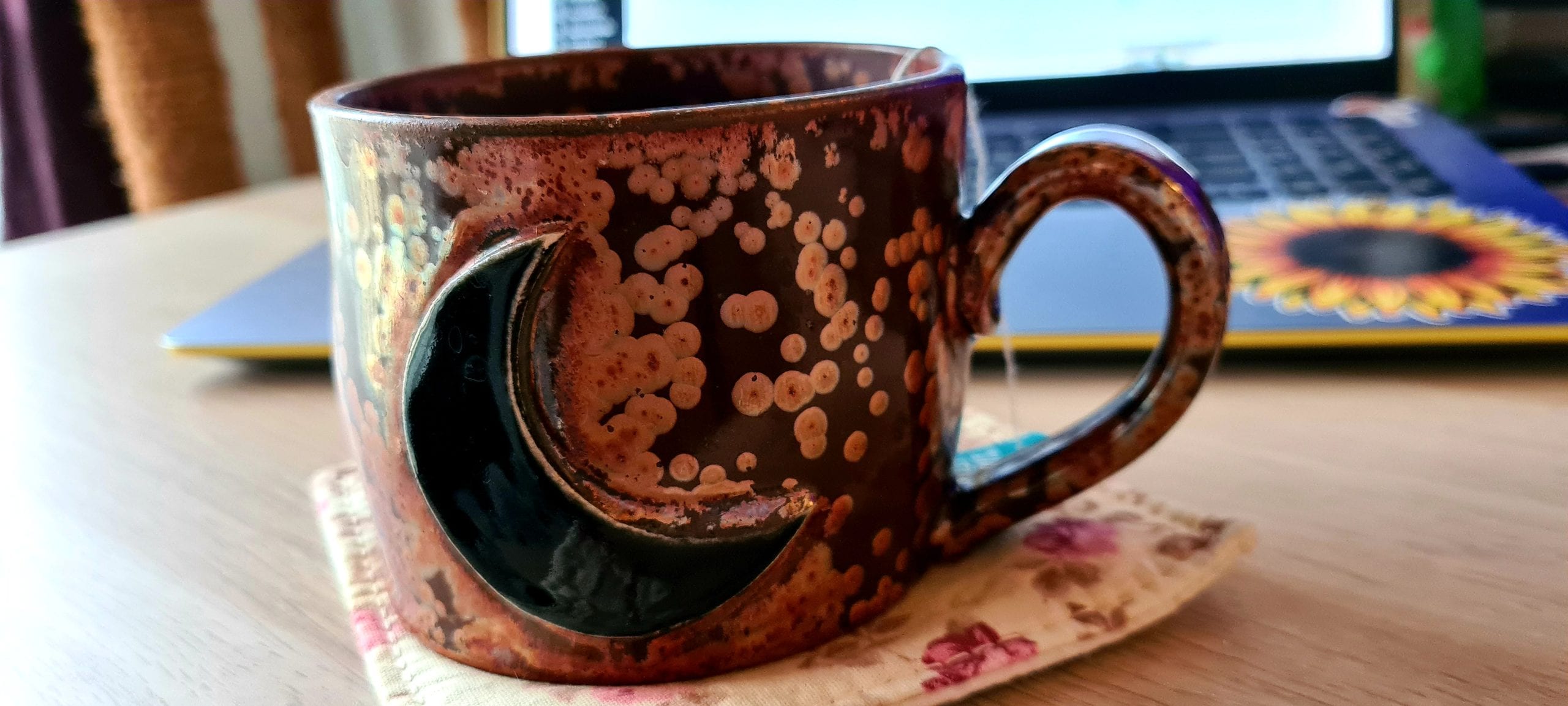 a large ceramic mug that looks like rusted tin