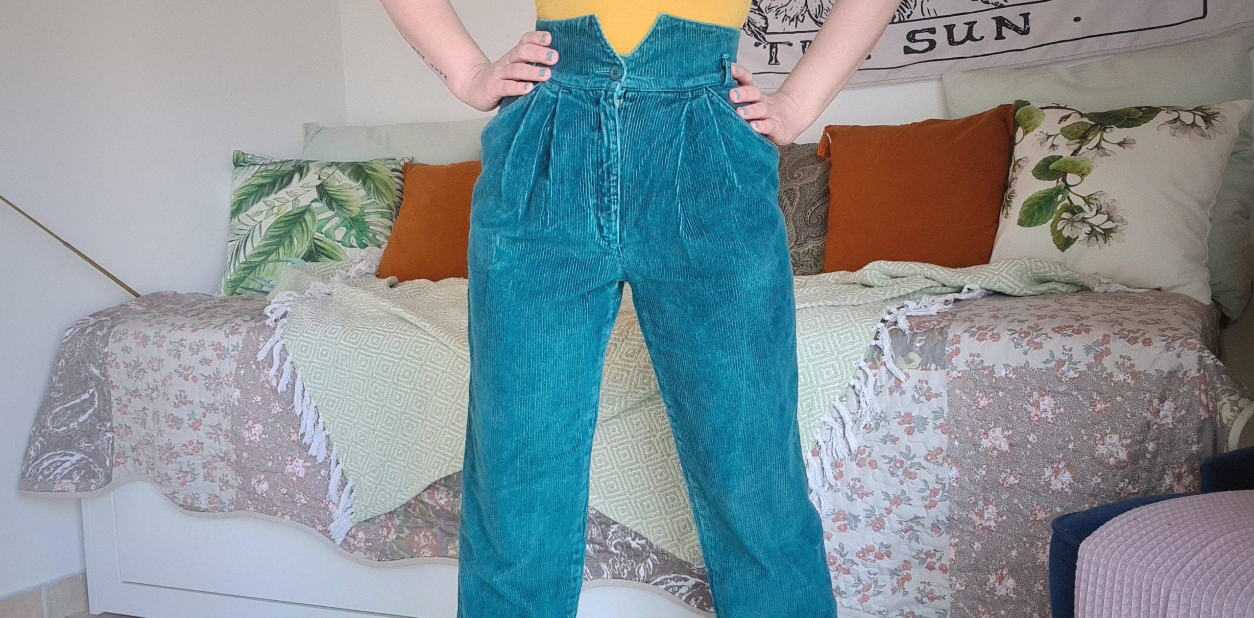 a person wearing a pair of emerald green corduroy trousers