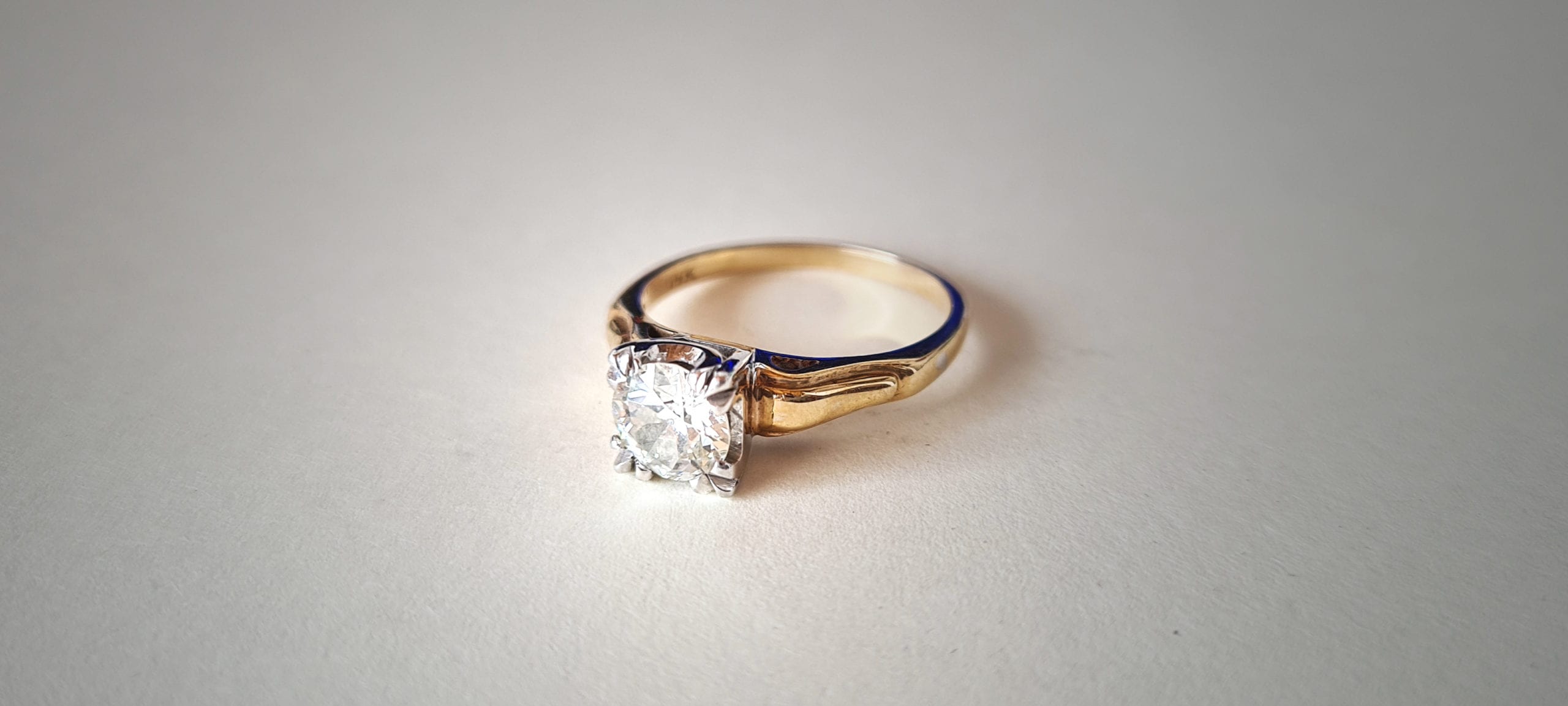 a diamond ring with a gold band