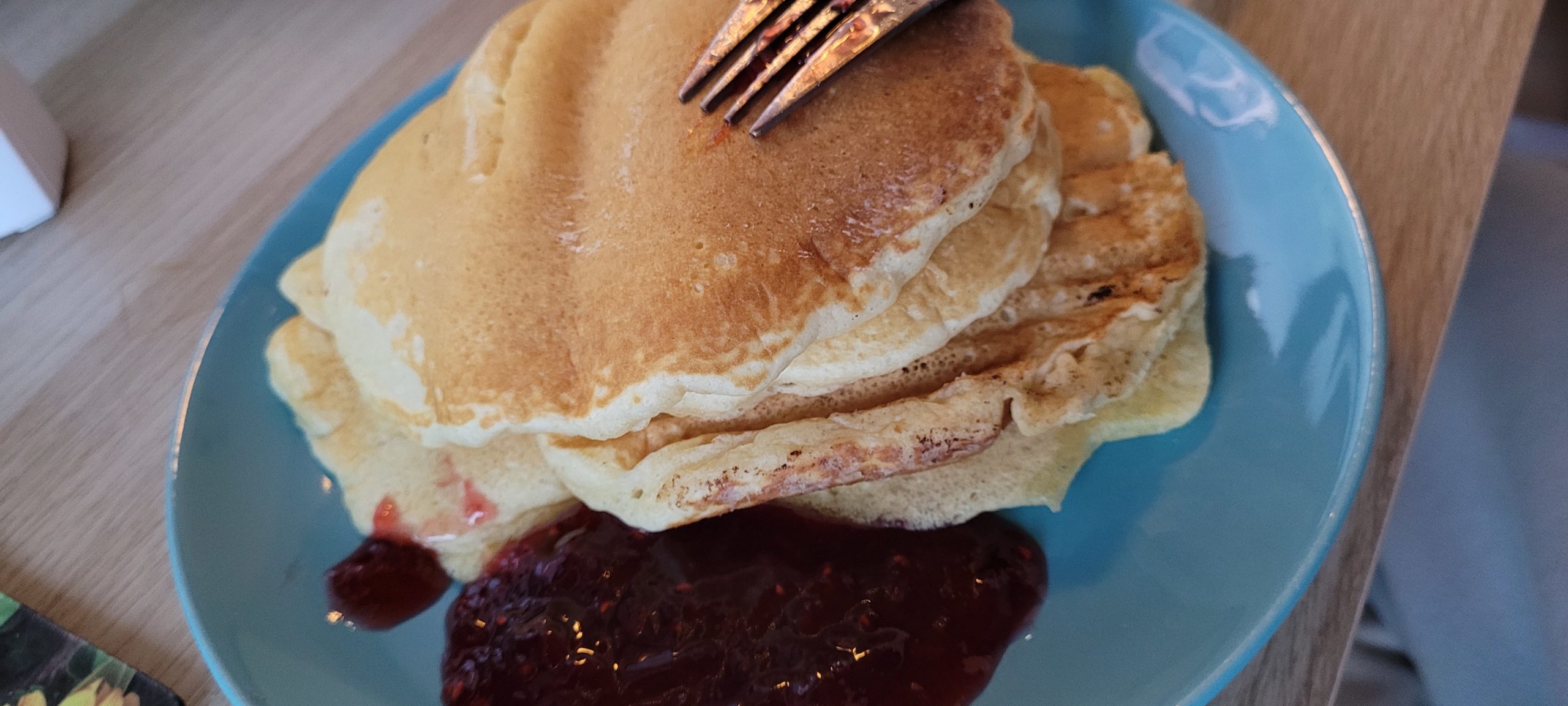 a plate with pancakes and strawberry jam