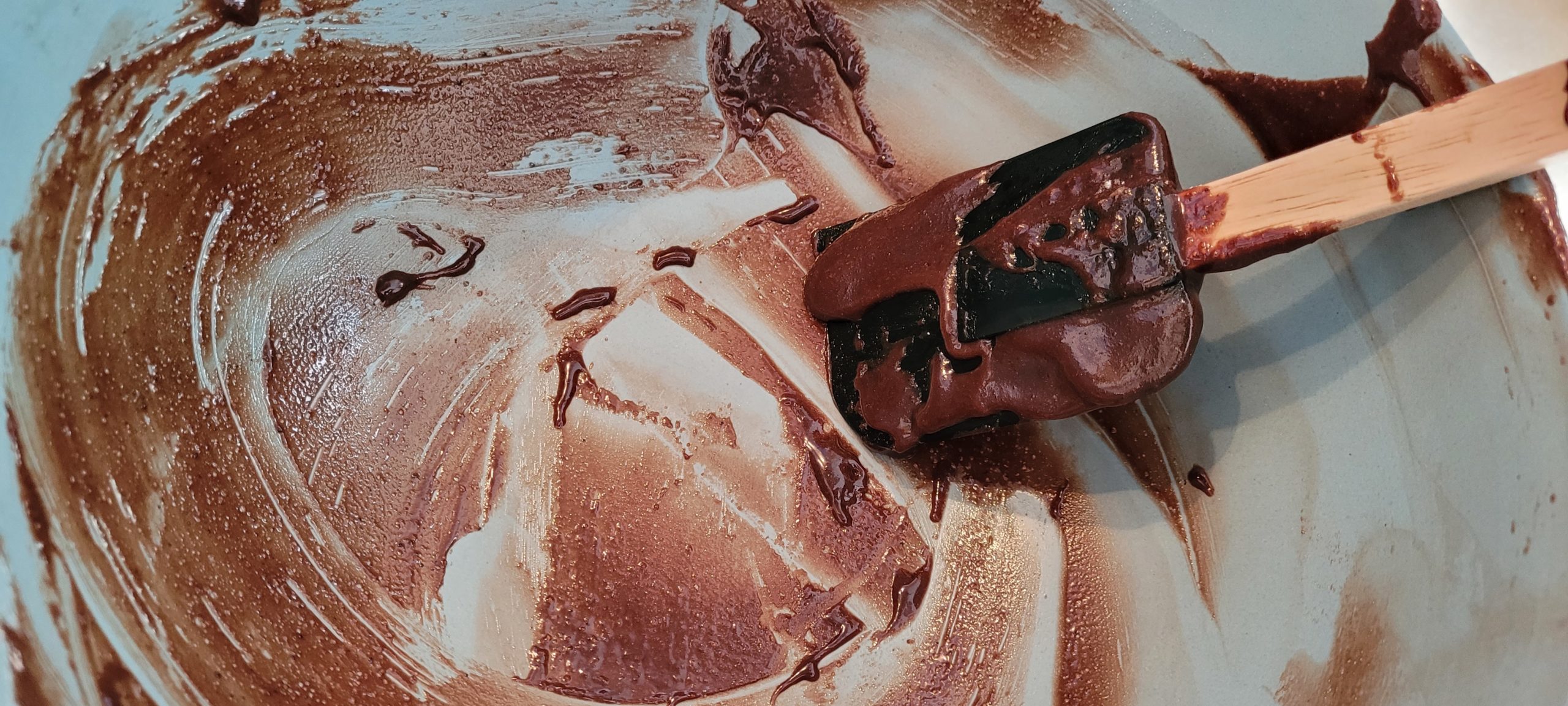 a bowl and spatula covered in chocolate