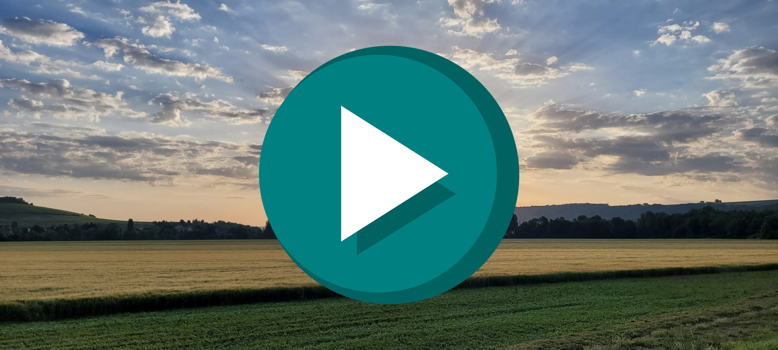 sunrise over fields with a play button on top