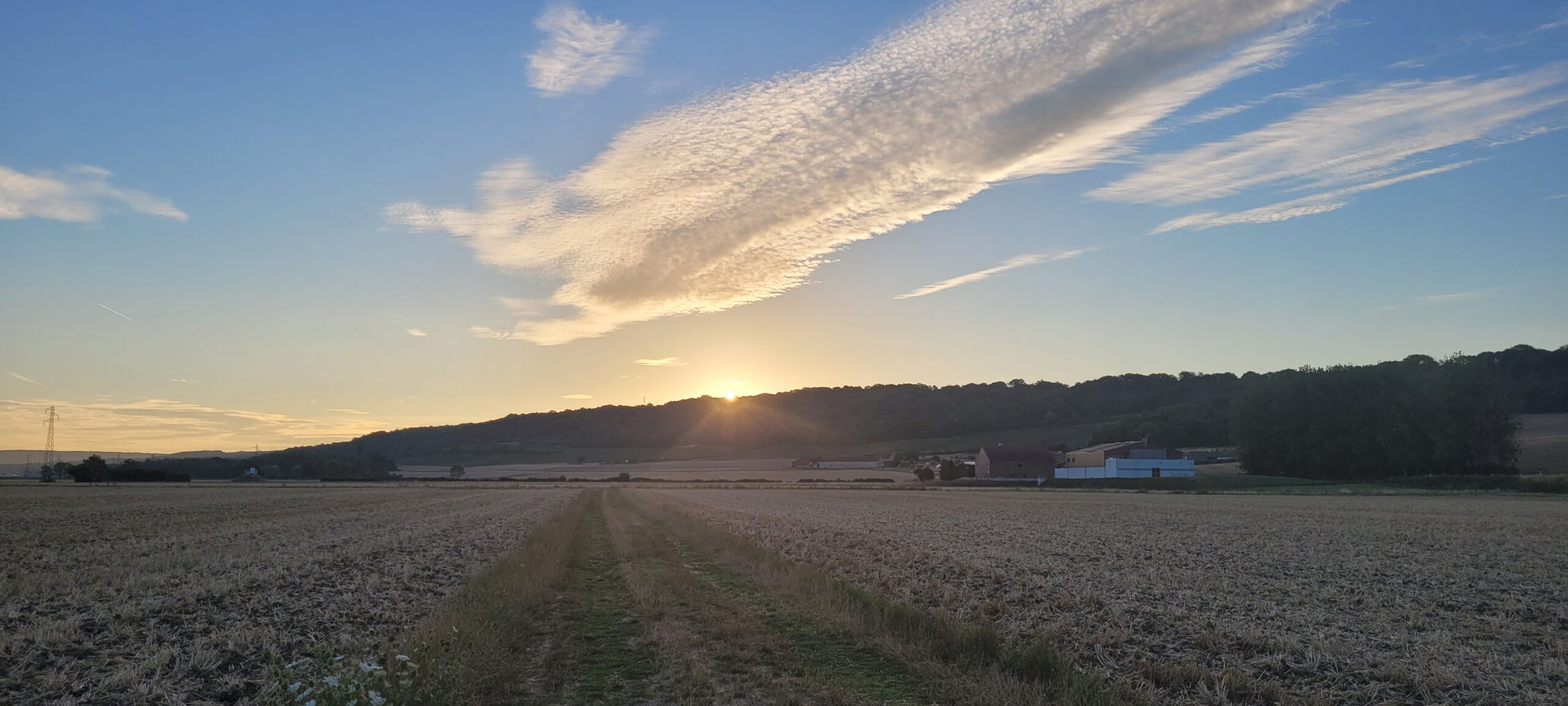 sunrise behind a hill