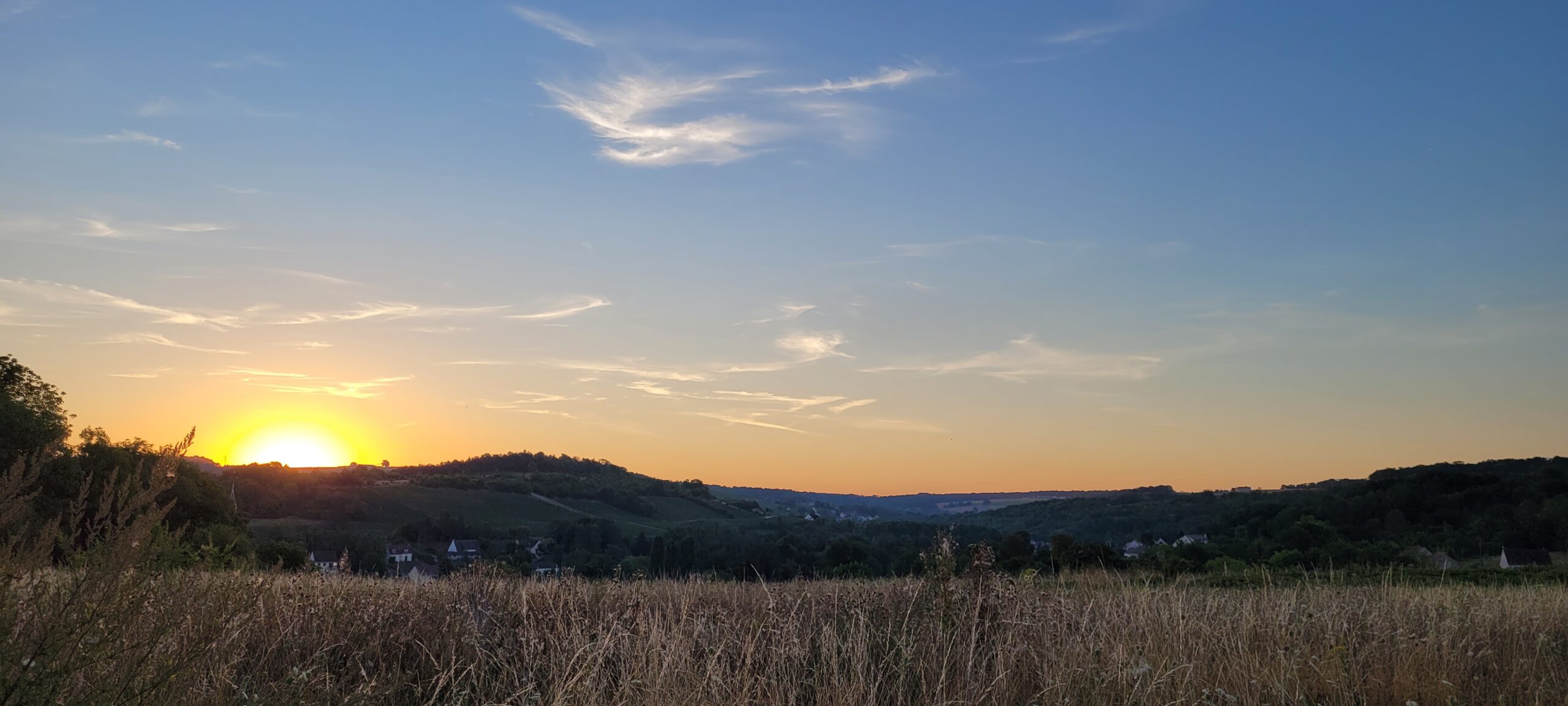 sunrise behind a hill