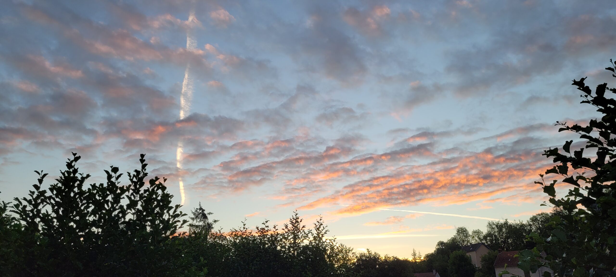 sunrise lighting up clouds purple and pink