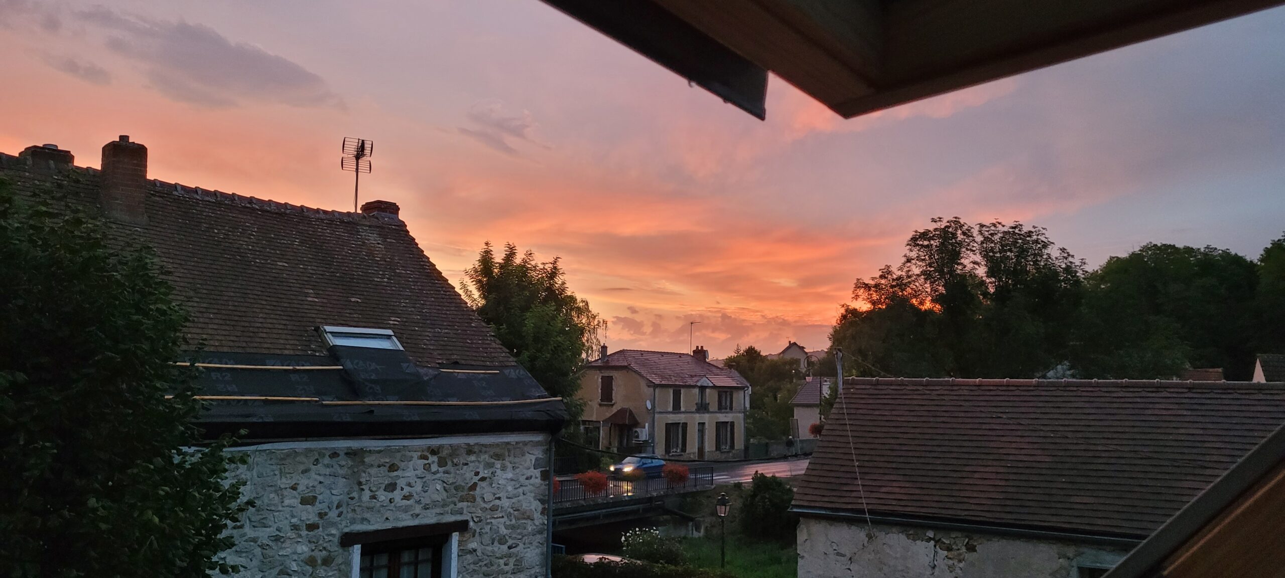 orange and pink sky above a village at sunrise