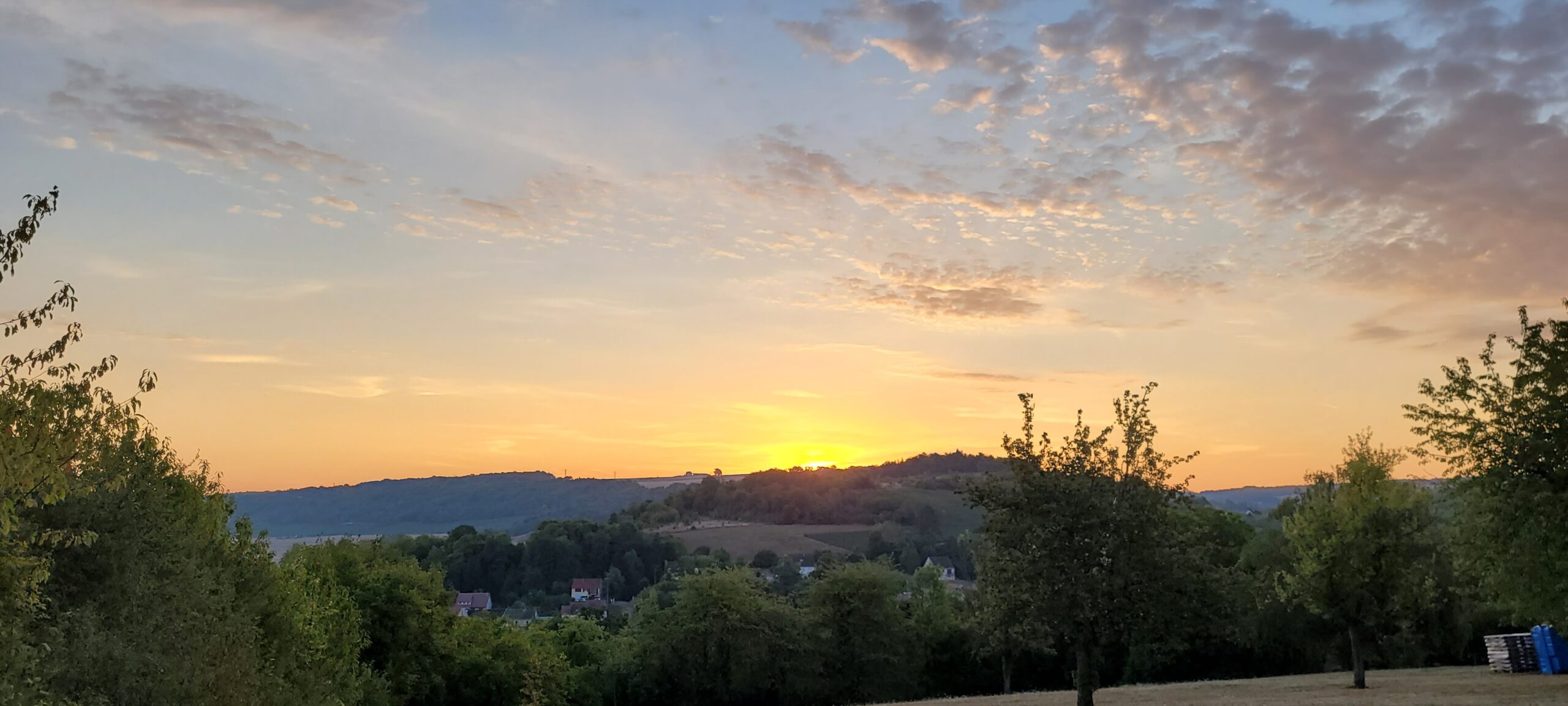 sunrise behind a hill in the French countryside