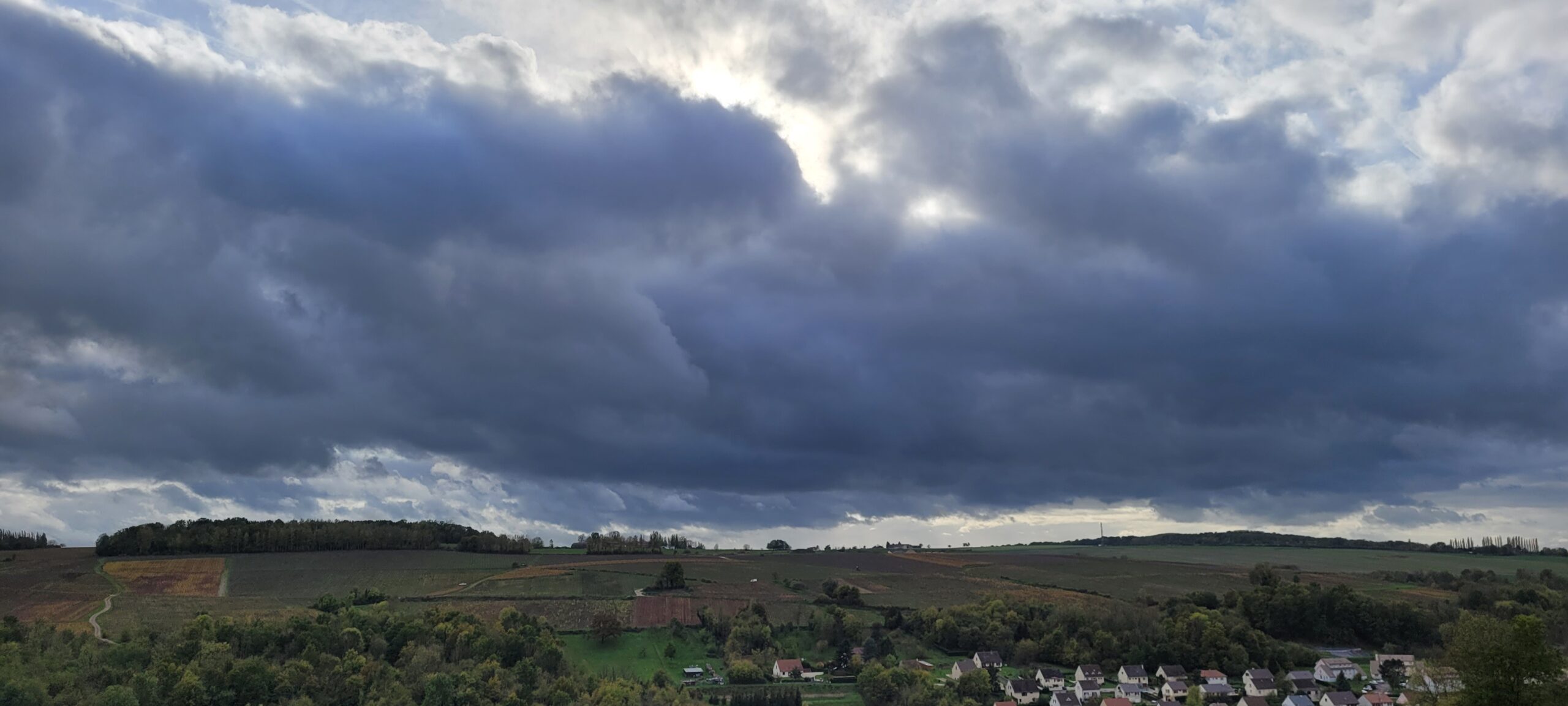 large dark clouds over French countryside