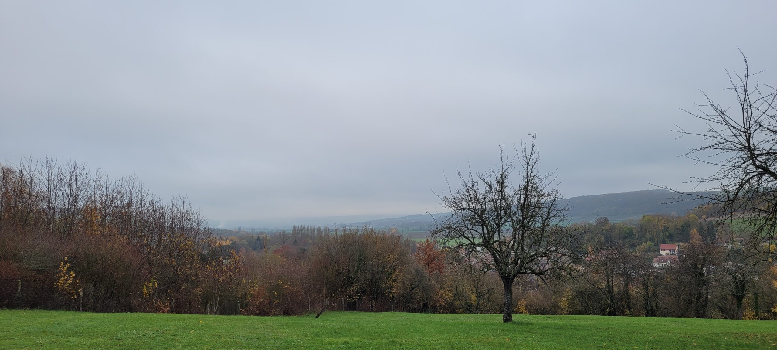 a grey cloudy sky over french countryside