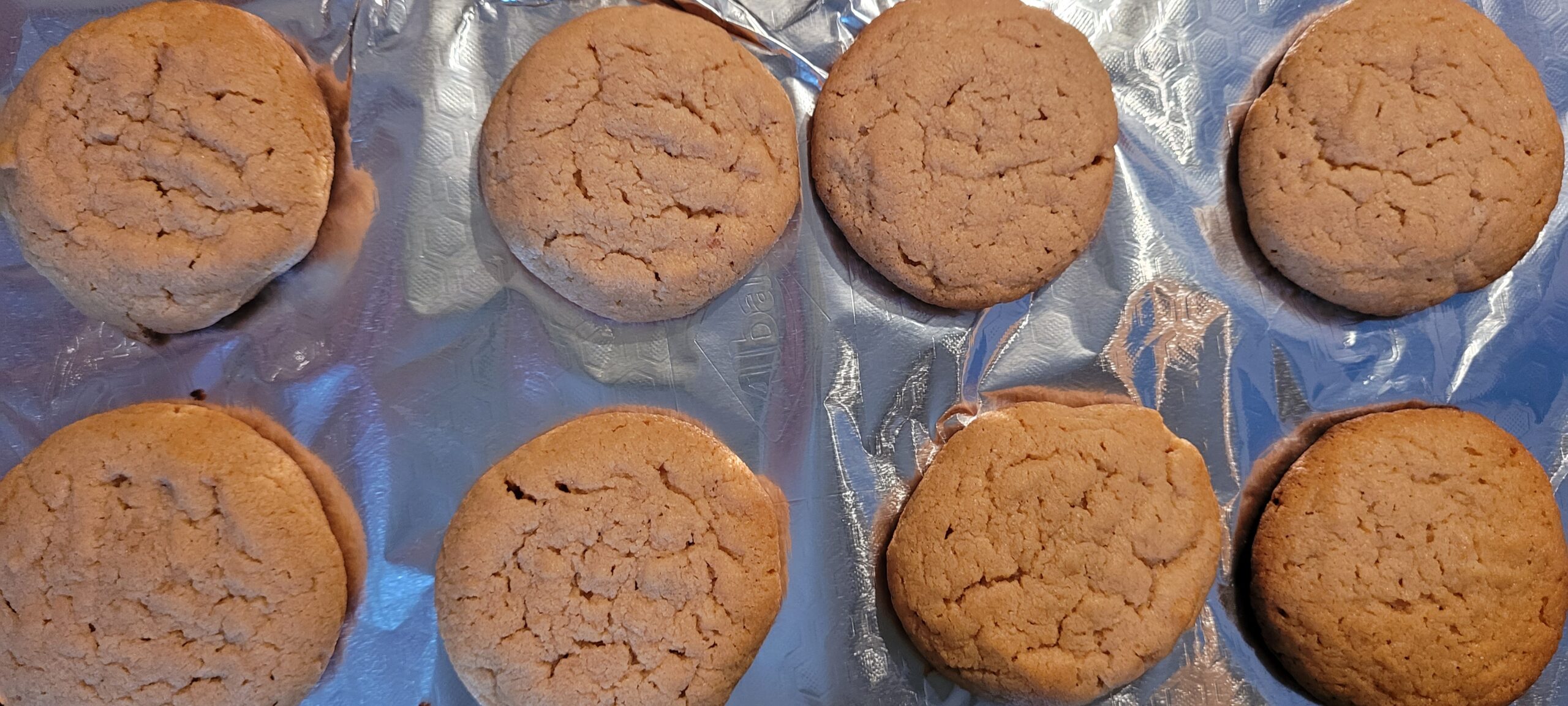 peanut butter cookies cooling on tin foil